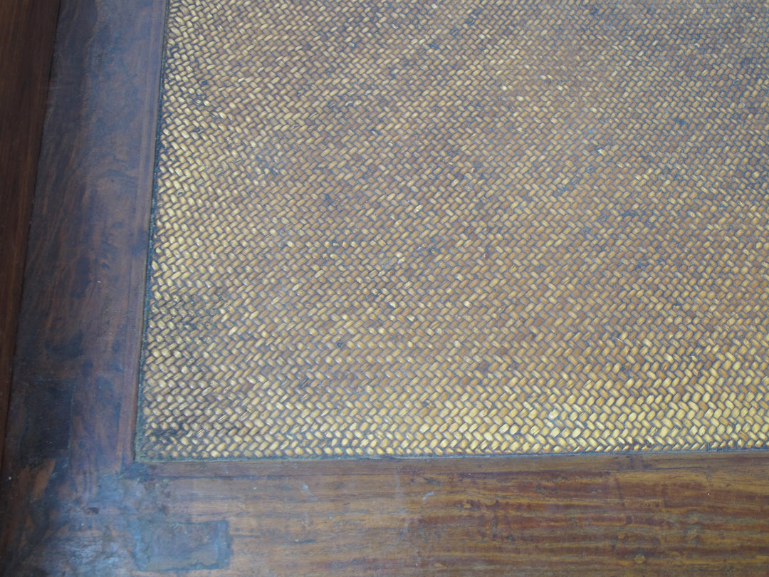 Close-up of a textured fabric with a wooden frame on the left side.