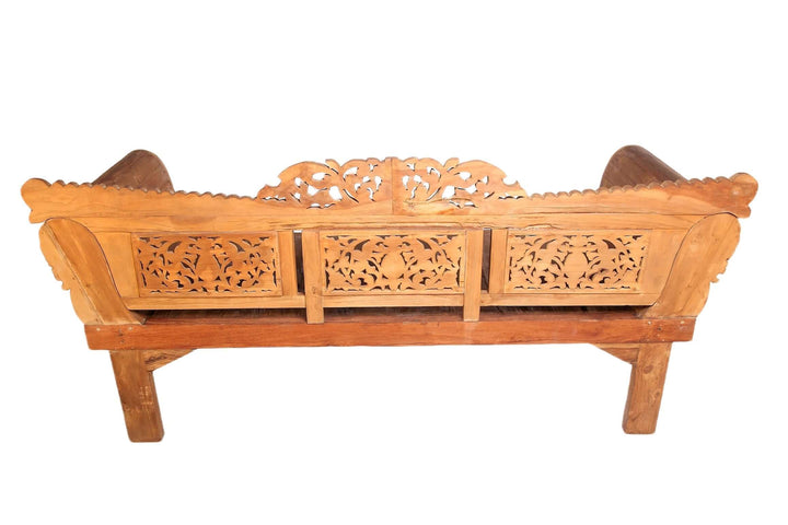 Wooden bench with intricate carvings on a white background