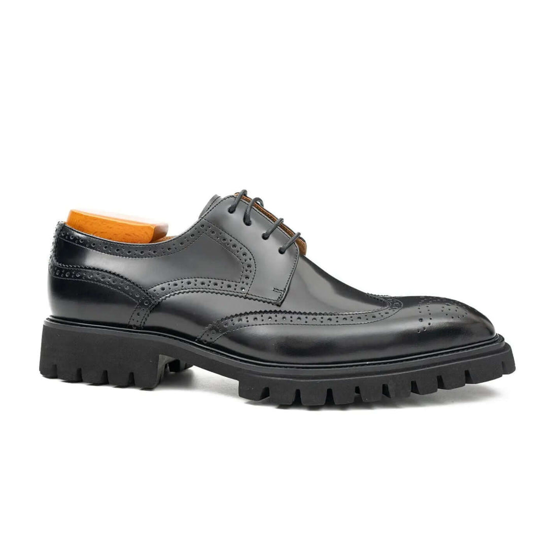 Black derby brogue shoes by DV DIVINCH in premium calfskin, featuring brogue details and a cushioned lug sole.