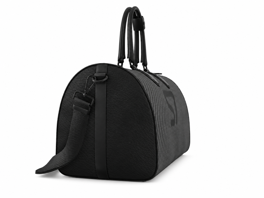 S7 Carbon Noir leather duffle bag with a graphite carbon-fiber-inspired print, centered black S7 monogram, black handles and solid black end panels.
