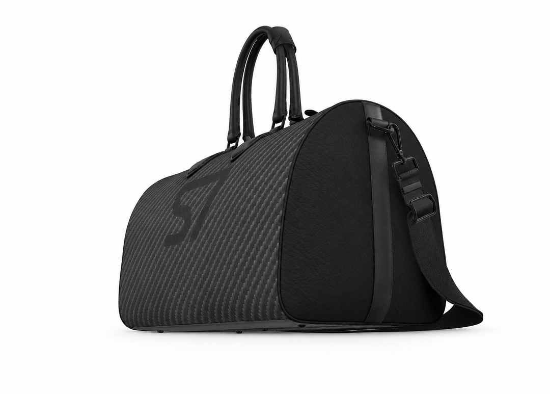 S7 Carbon Noir leather duffle bag with a graphite carbon-fiber-inspired print, centered black S7 monogram, black handles and solid black end panels.