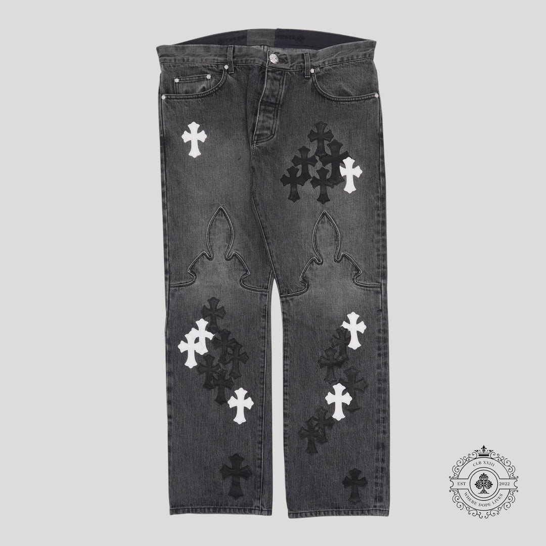 Black jeans with white and black cross patterns on a light gray background