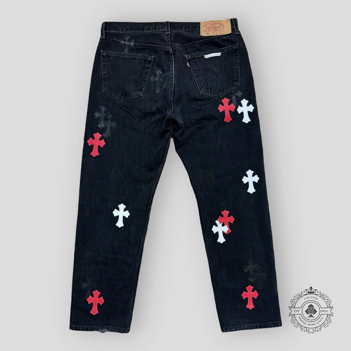 Black jeans with colorful cross patterns on a white background