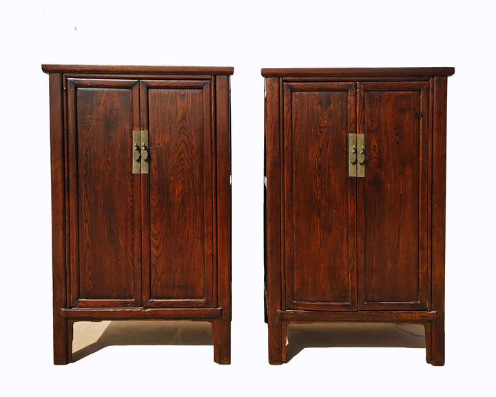 Pair of wooden cabinets with brass handles on a white background