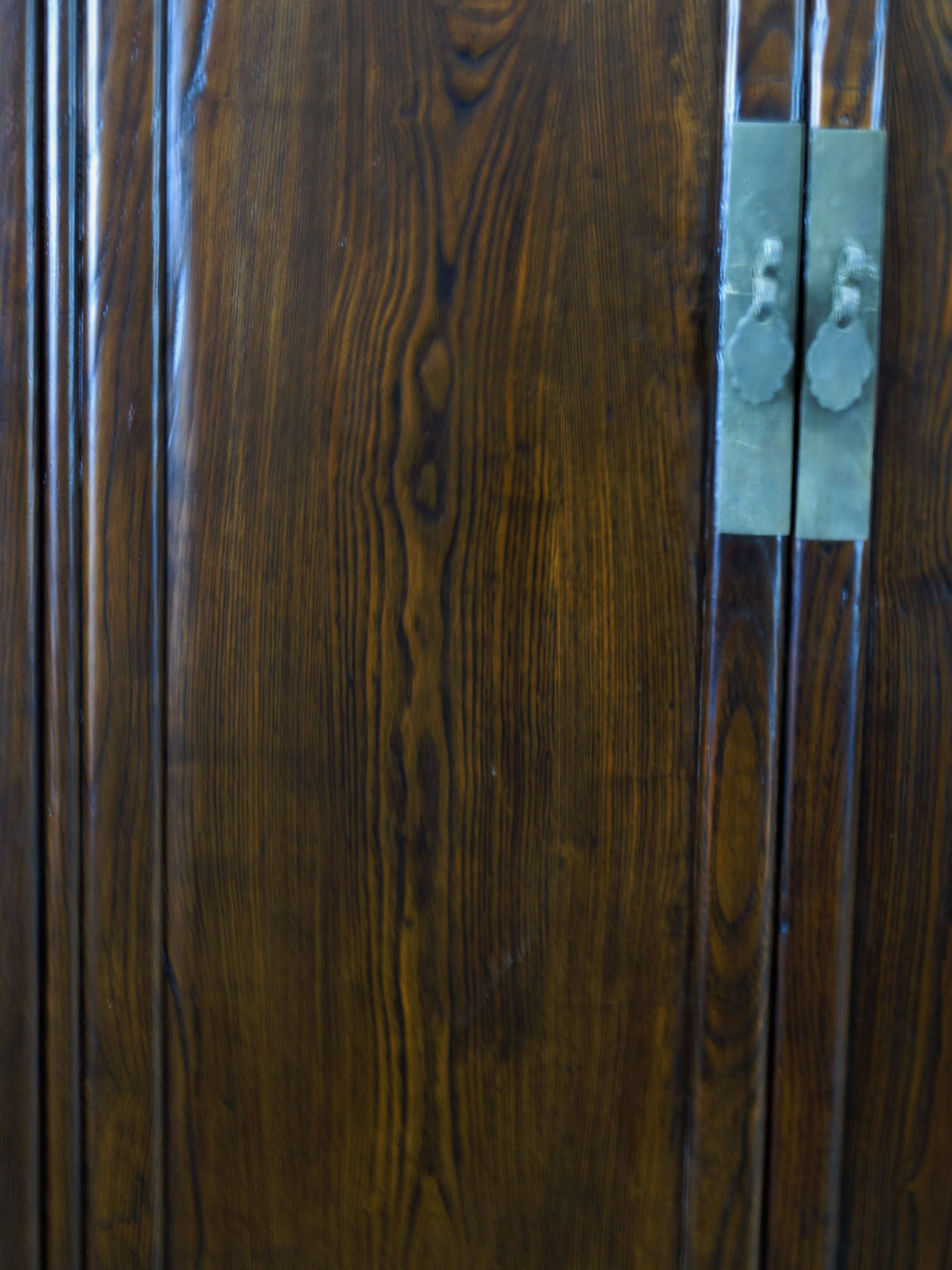 Close-up of a wooden door with a metal handle