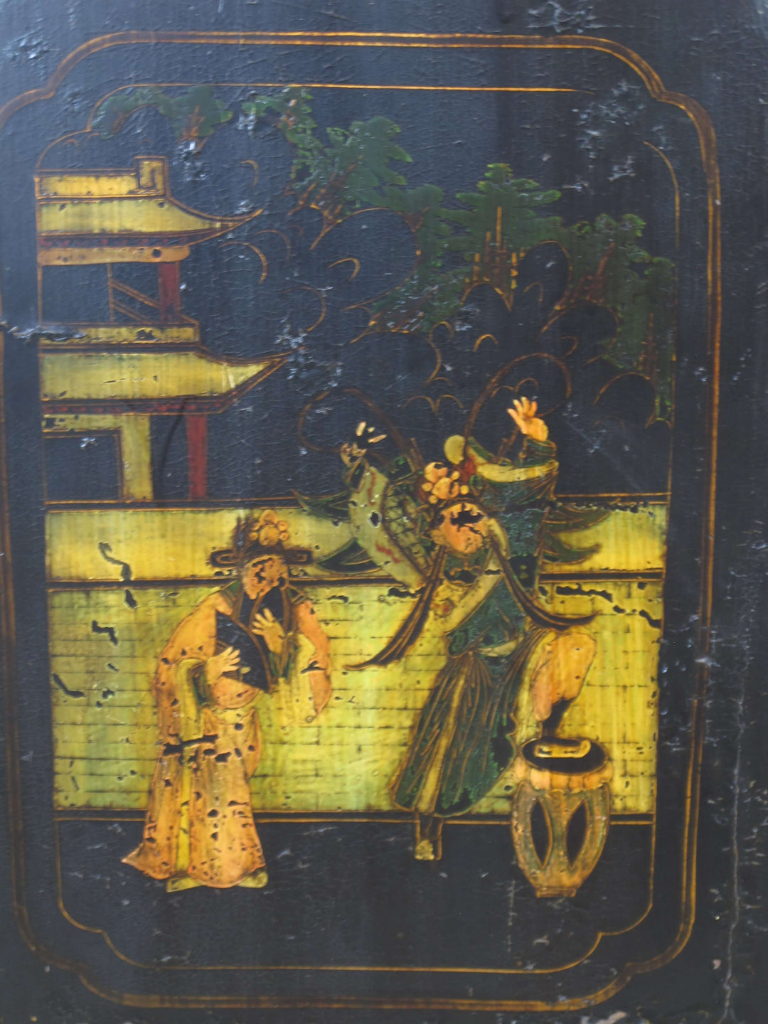 Decorative panel with two figures in traditional attire against a dark background