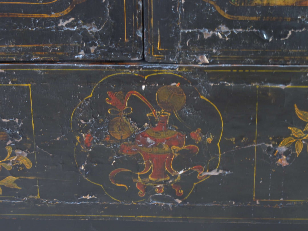 Decorative black surface with red and gold artwork