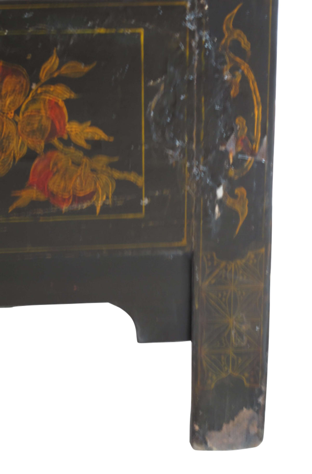 Decorative corner of a piece of furniture with floral painting and gold detailing.