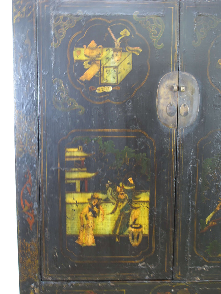 Decorative wooden cabinet with intricate gold artwork on a dark background