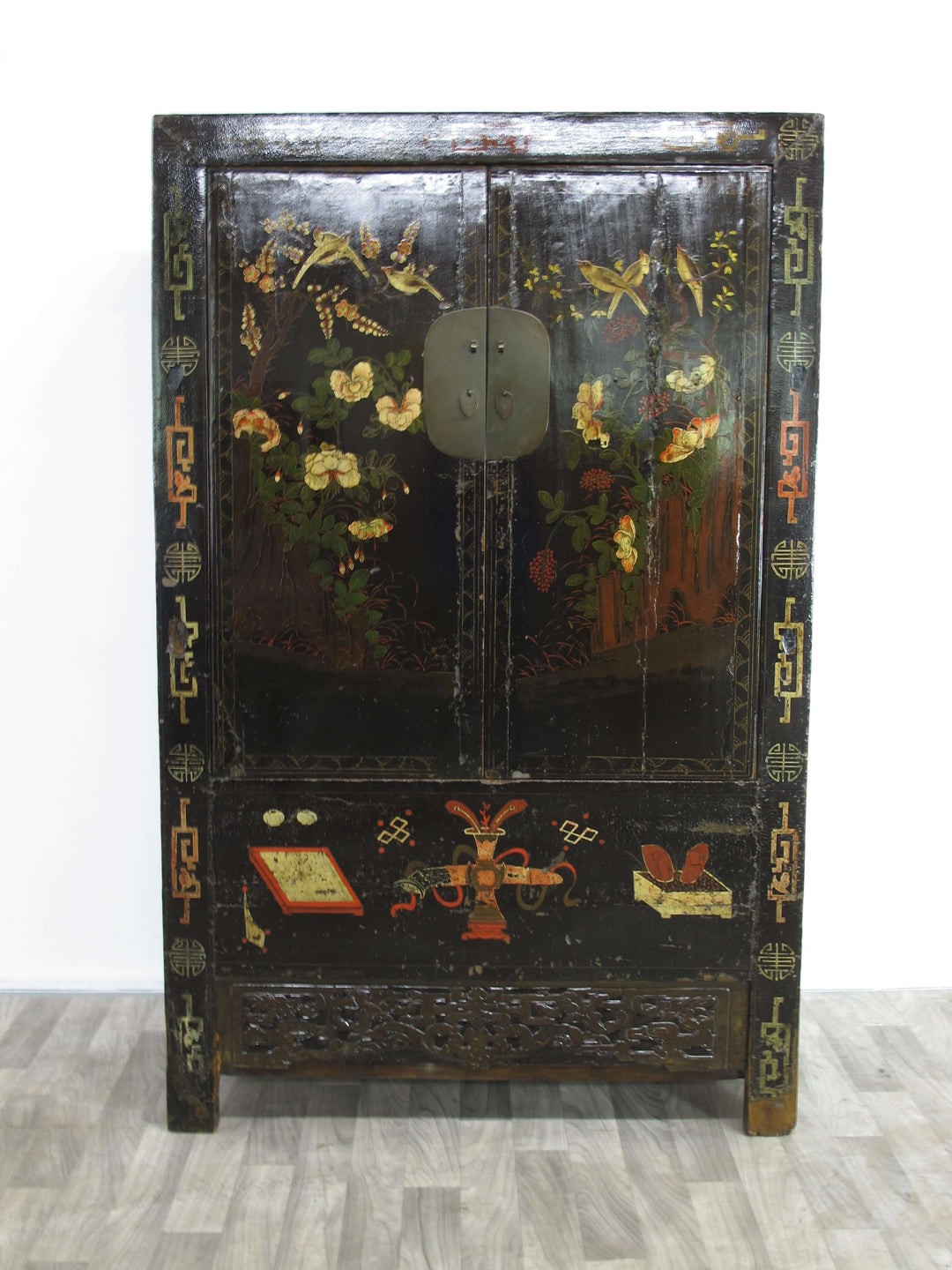 Decorative wooden cabinet with floral and butterfly patterns on a white background