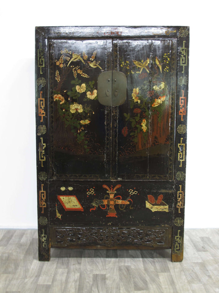 Decorative wooden cabinet with floral and butterfly patterns on a white background