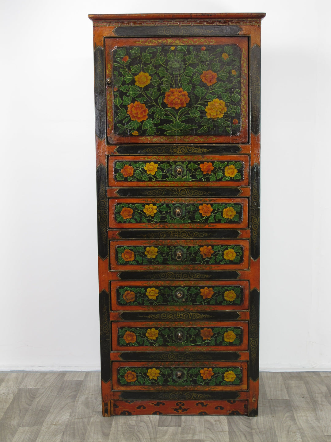 Decorative wooden cabinet with floral patterns on a white background