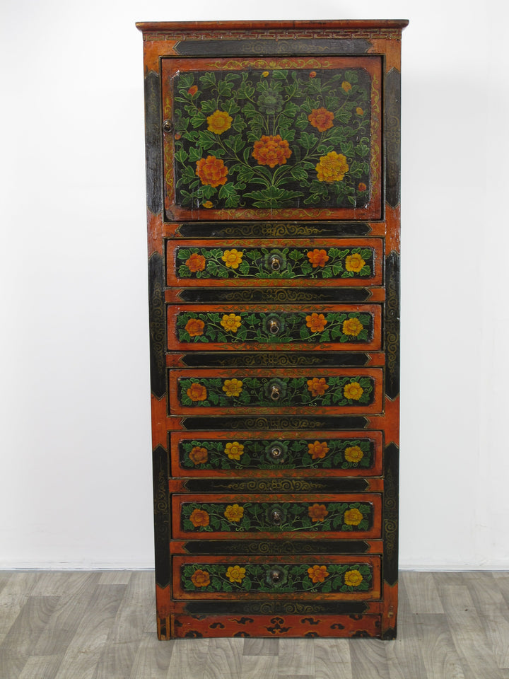 Decorative wooden cabinet with floral patterns on a white background