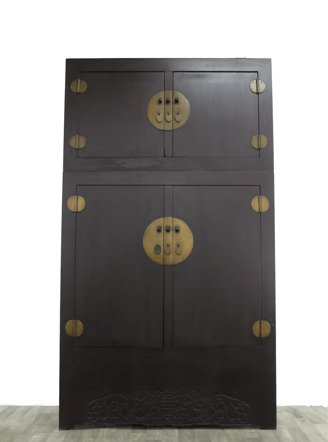 Dark wooden cabinet with brass hardware on a white background