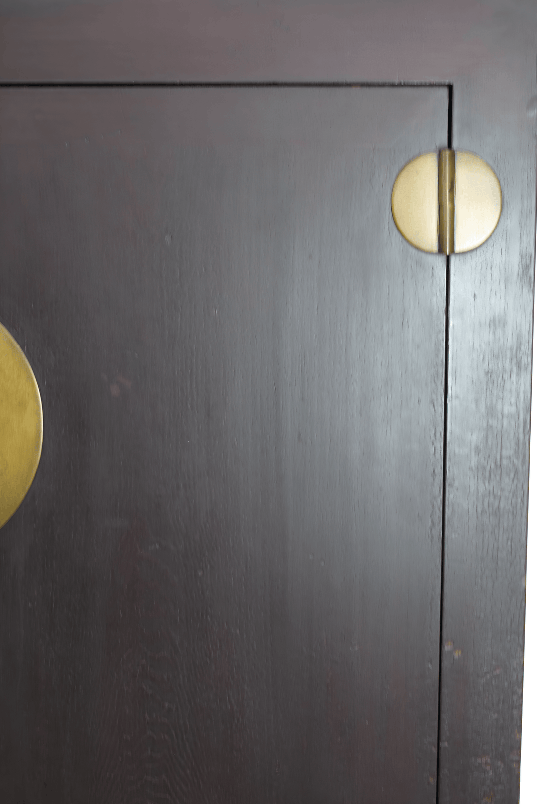 Dark wooden cabinet with gold circular handles