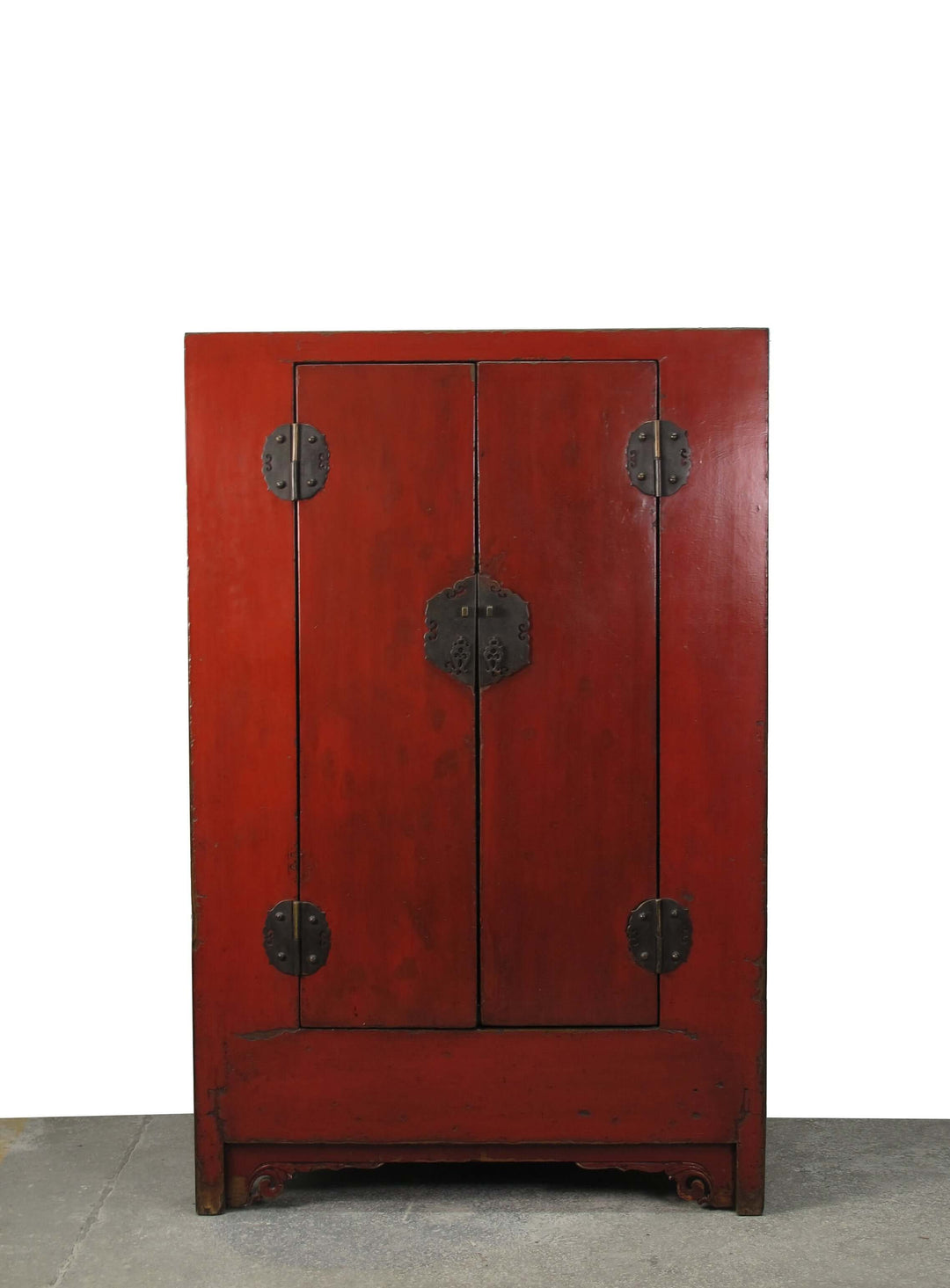 Red wooden cabinet with black handles on a white background
