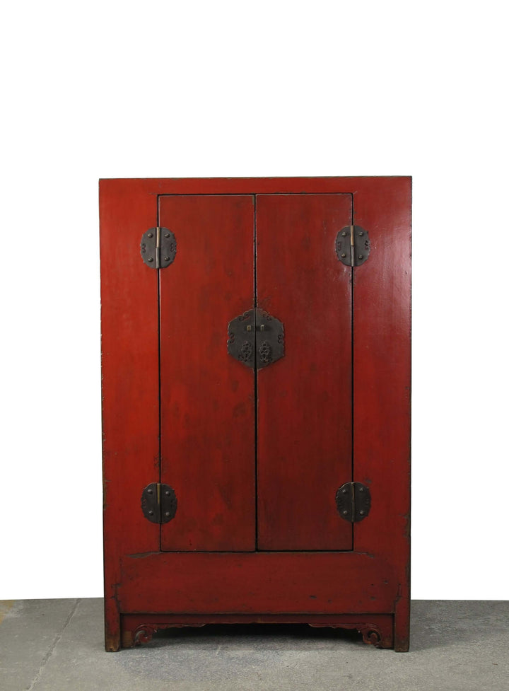 Red wooden cabinet with black handles on a white background