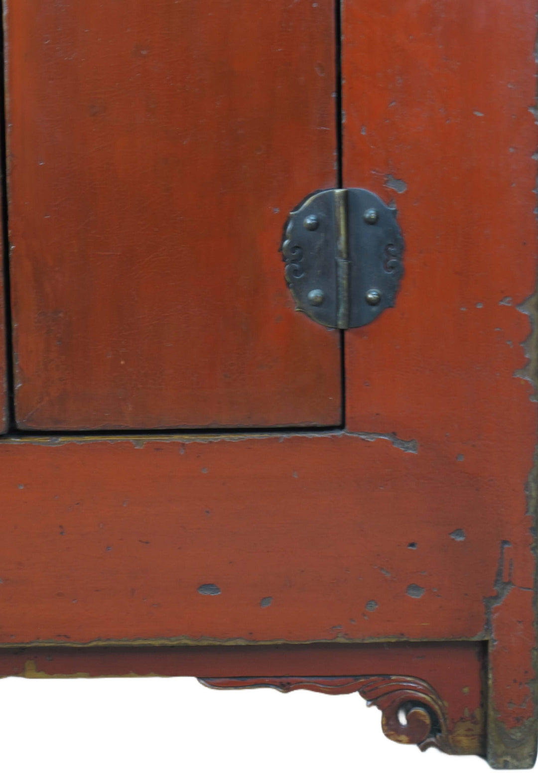 Close-up of a red wooden cabinet with a metal handle
