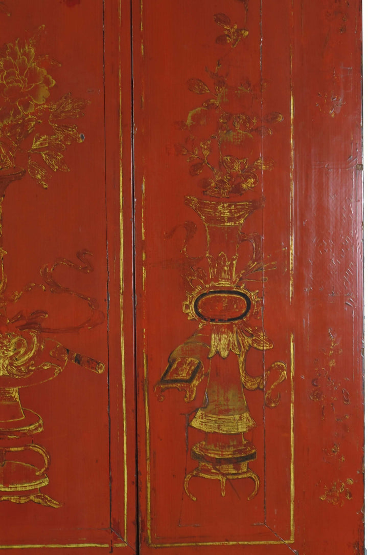 Red wooden panel with gold intricate designs