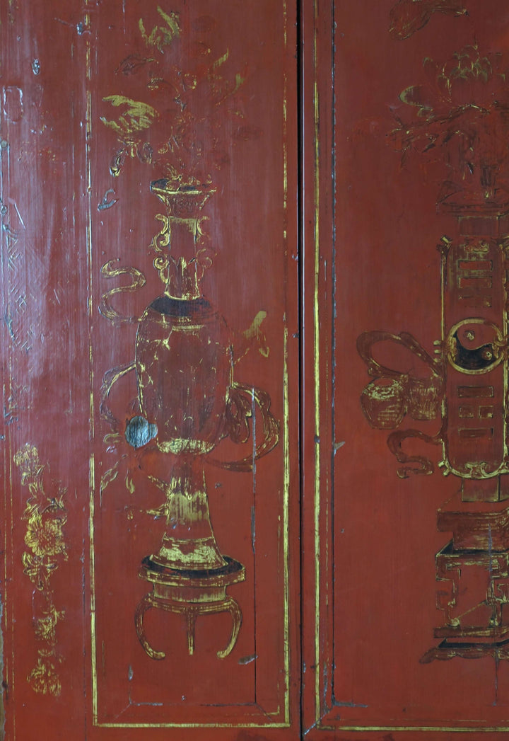 Red wooden panel with gold intricate carvings and text