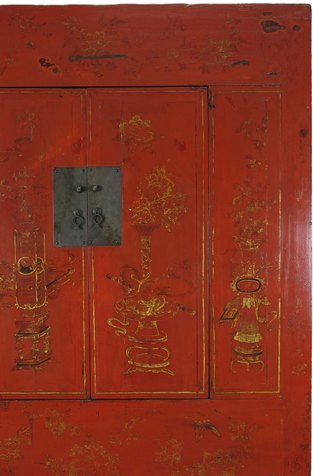 Red wooden cabinet with gold decorative elements and a central lock.