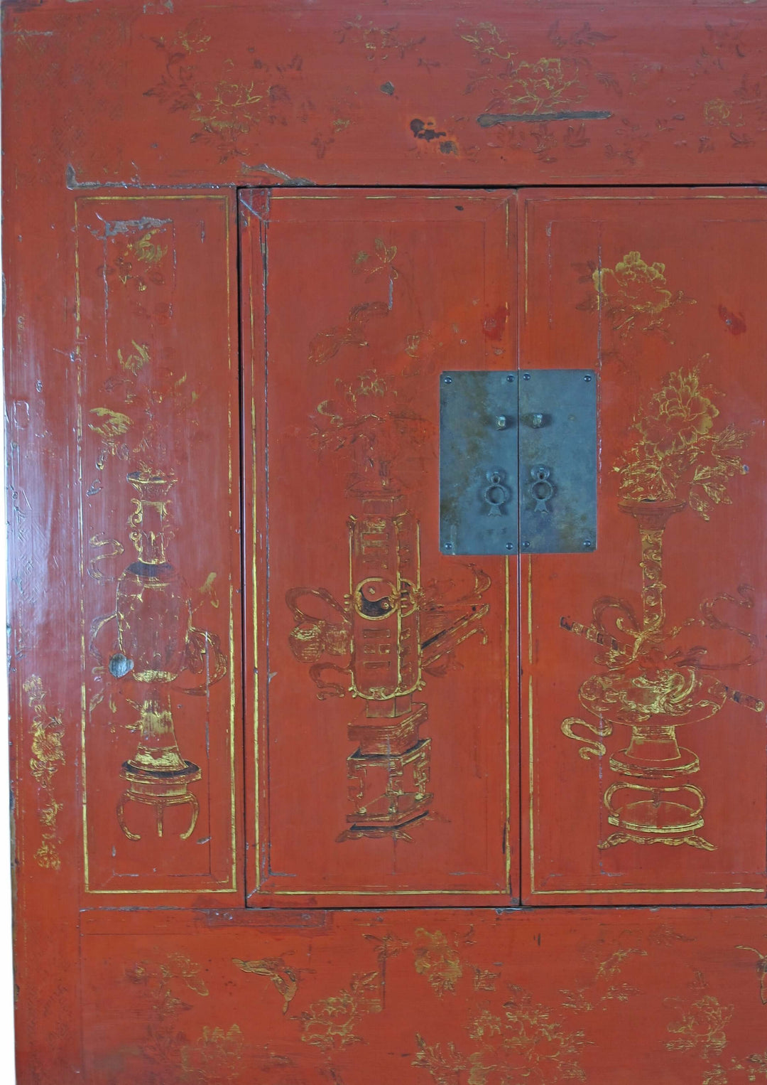 Red wooden cabinet with gold decorative elements and a blue handle.