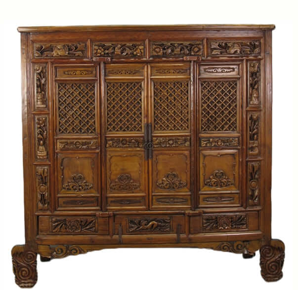 Carved wooden cabinet with intricate designs on a white background