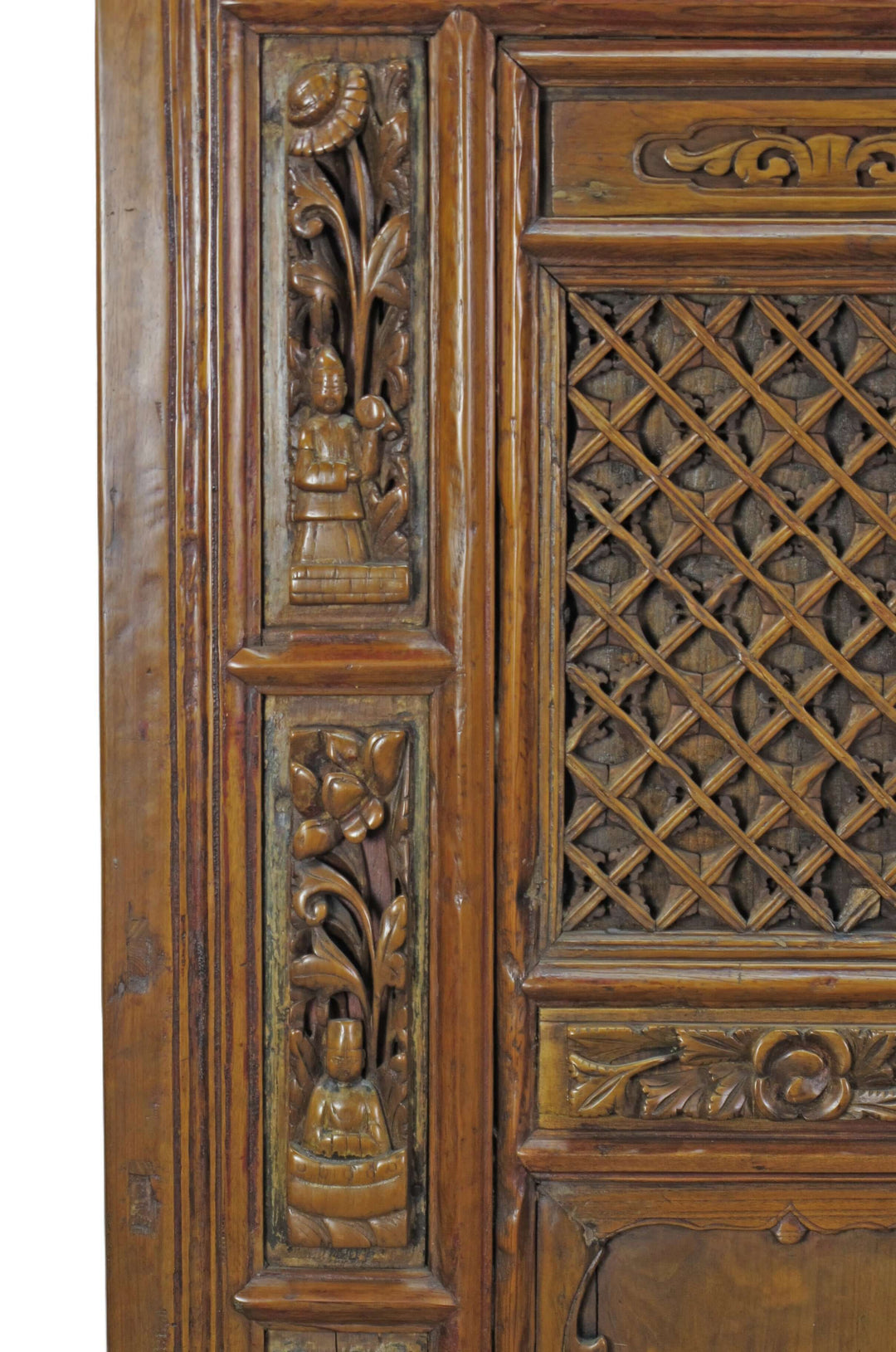 Carved wooden panel with intricate patterns and a lattice design