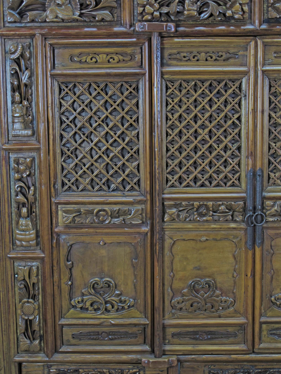 Close-up of intricately carved wooden panel with lattice patterns