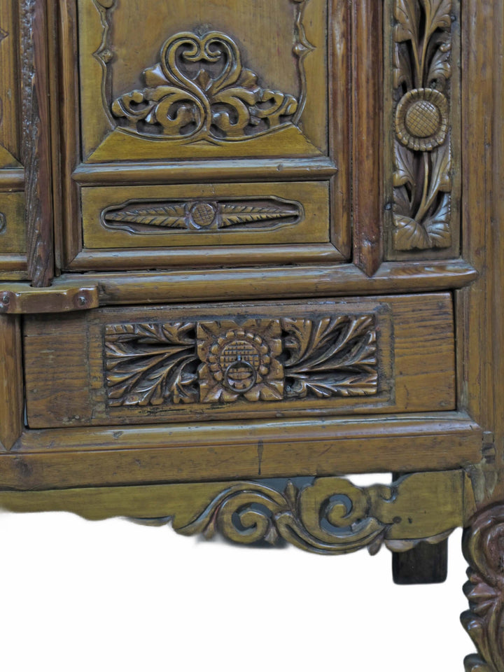 Close-up of an ornate wooden cabinet with intricate carvings.