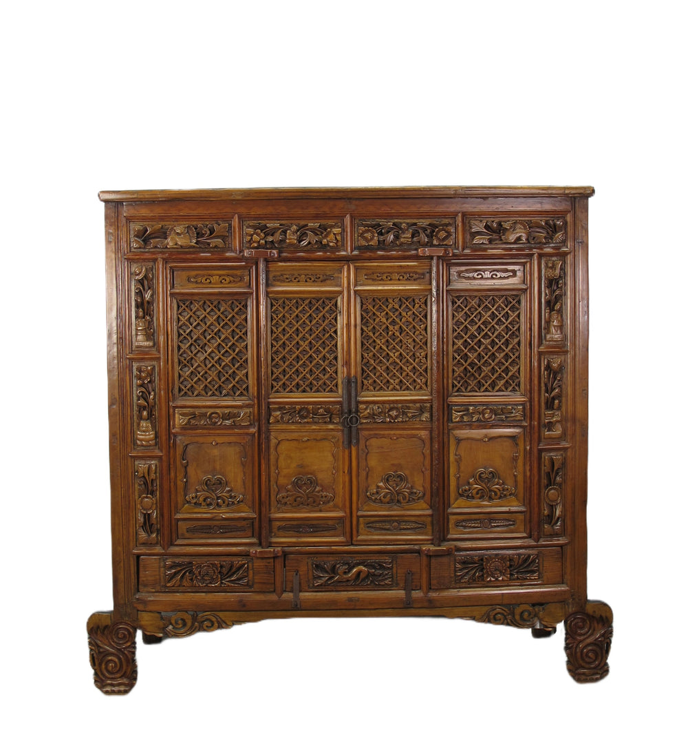Carved wooden cabinet with intricate designs on a white background