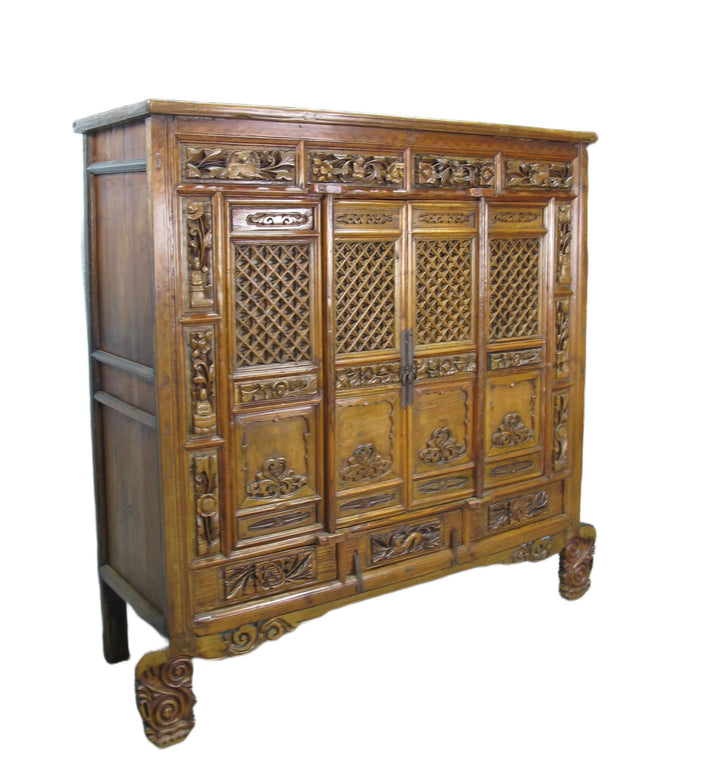 Carved wooden cabinet with intricate designs on a white background