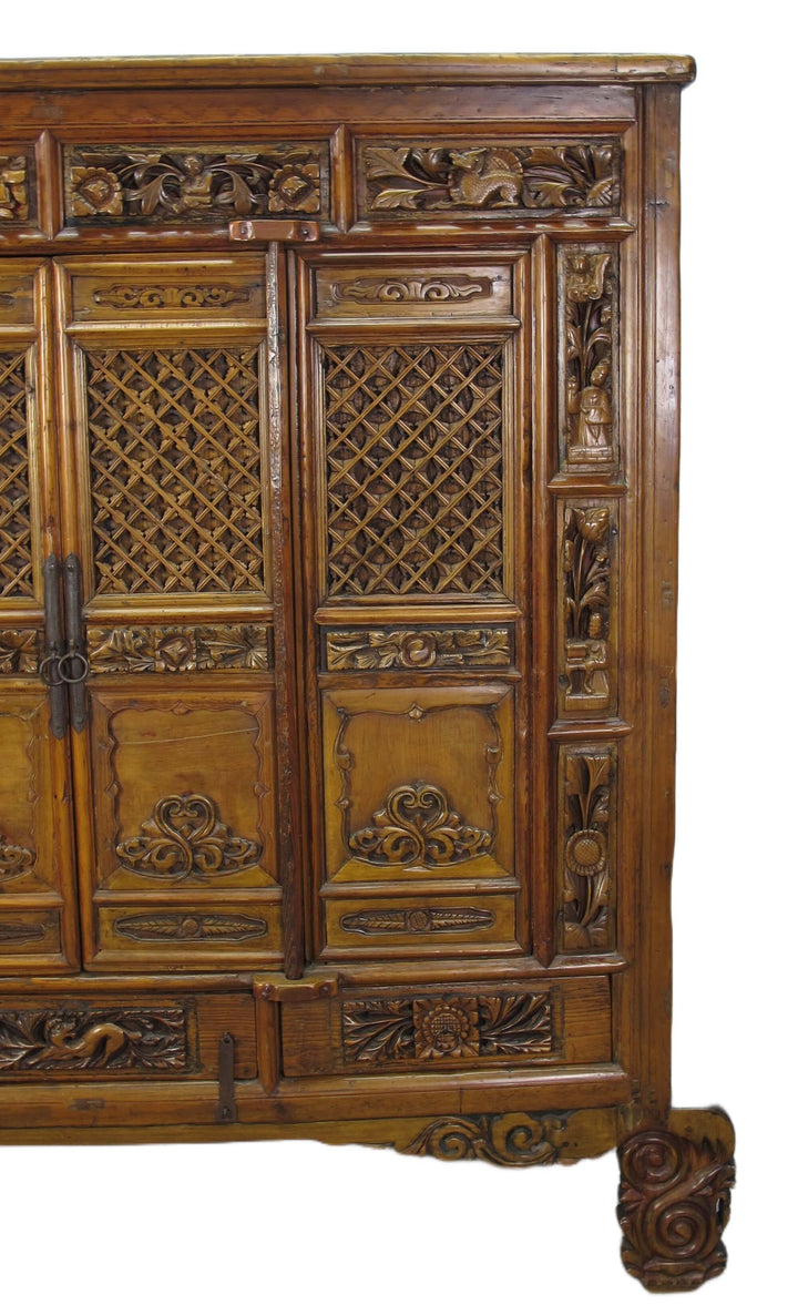 Carved wooden cabinet with intricate patterns on a white background