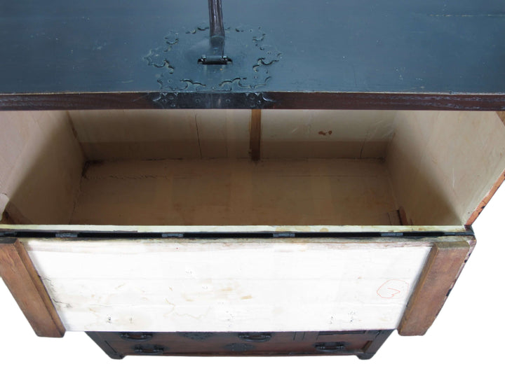 Vintage air hockey table with glass top and wooden base against a blue wall.