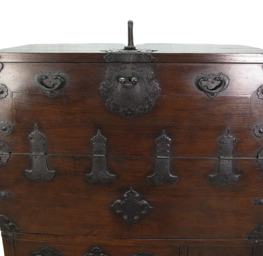 Close-up of an old wooden chest with metal fixtures on a white background