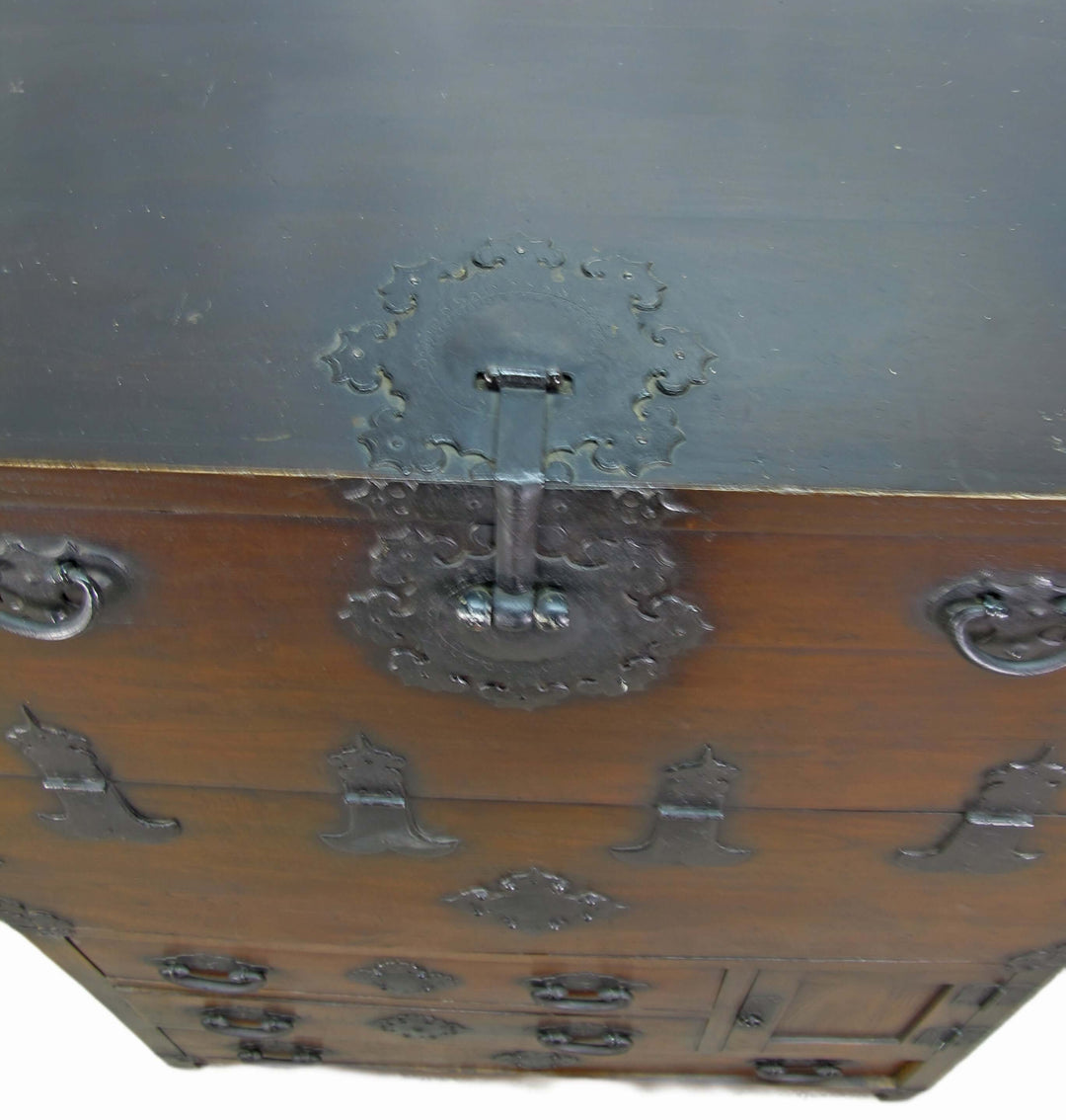 Vintage wooden trunk with metal handles and decorative locks on a white background