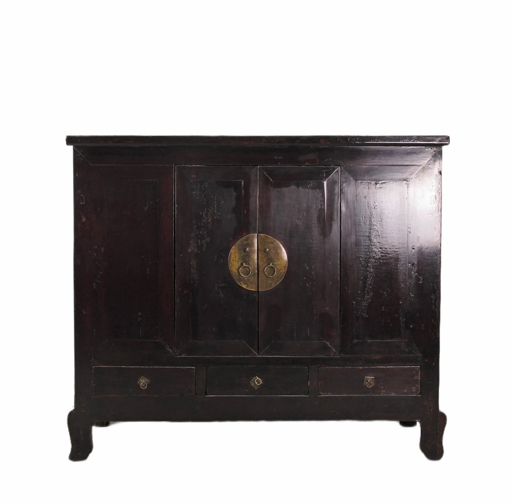 Black wooden cabinet with brass handle on a white background
