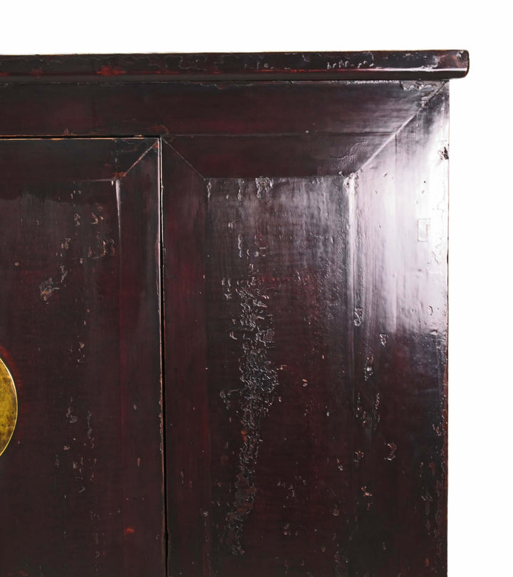 Dark wooden cabinet with a gold handle on a white background