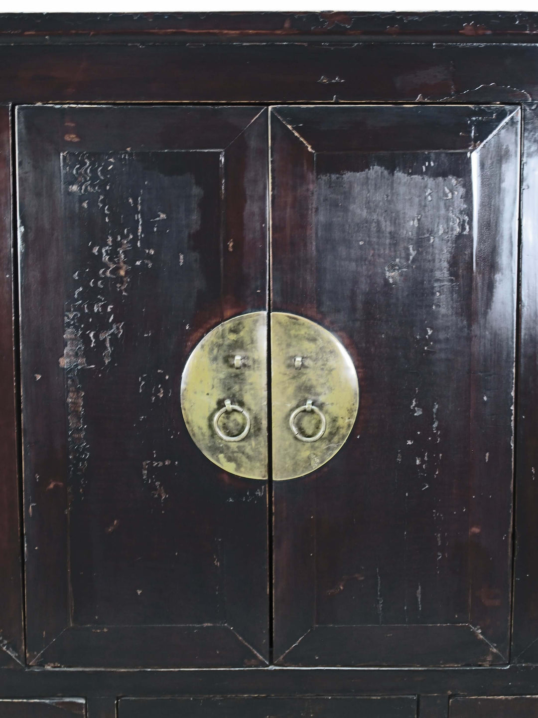 Dark wooden cabinet with brass handle