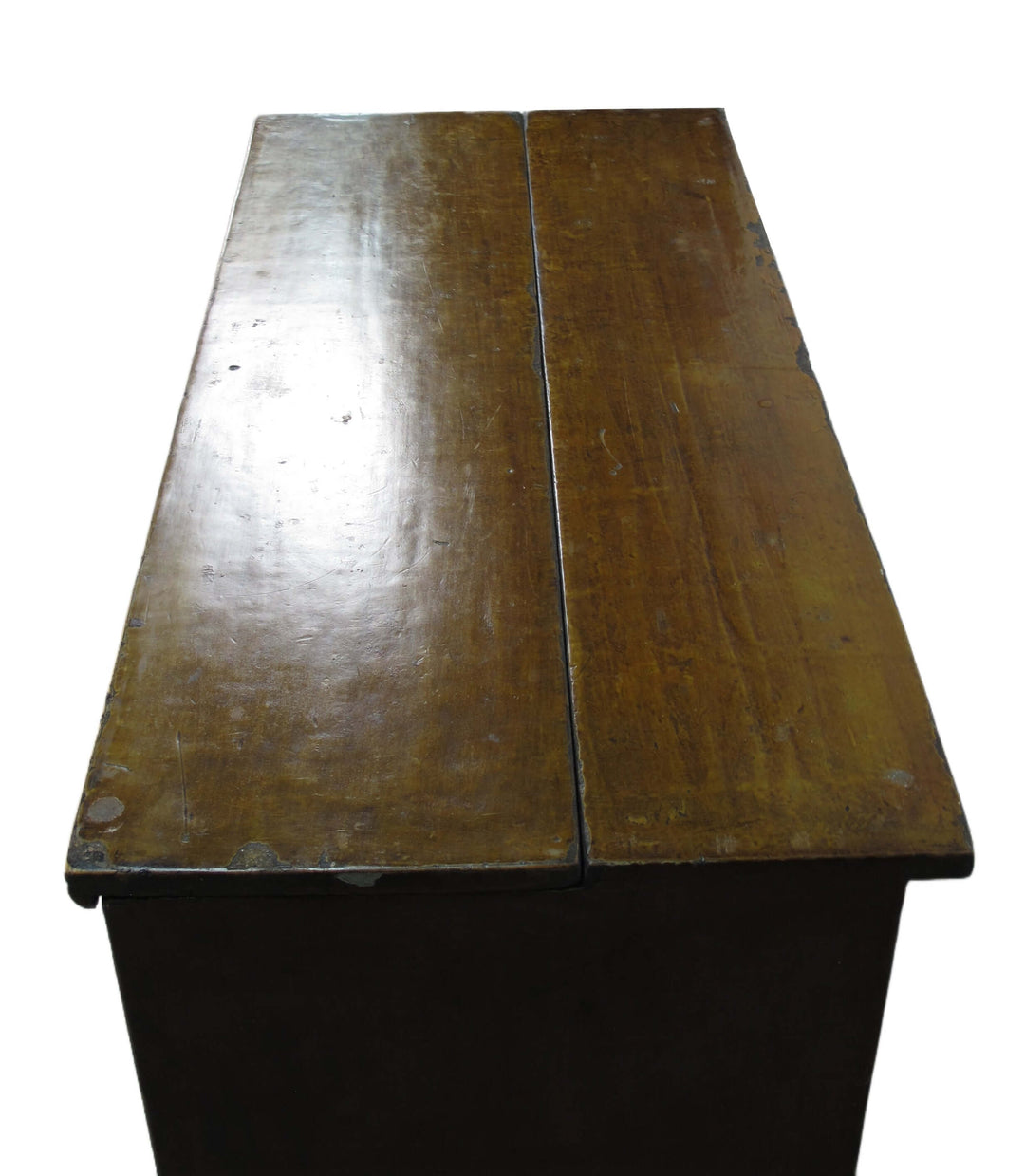Wooden desk with a visible grain and wear on the surface