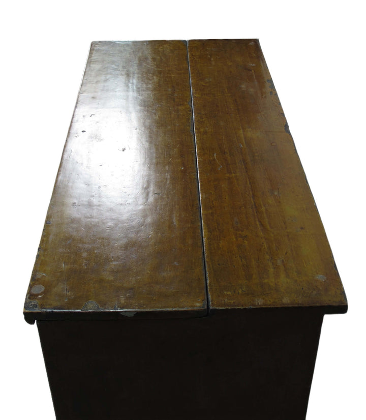 Wooden desk with a visible grain and wear on the surface
