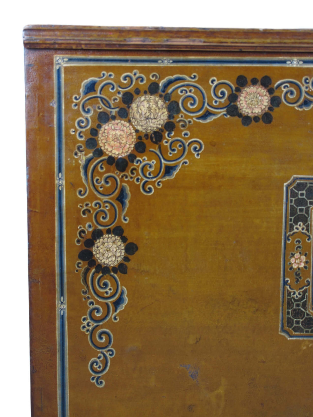 Decorative corner of a wooden surface with intricate floral patterns