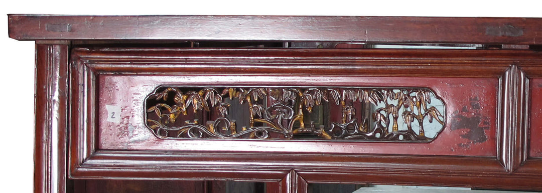 Close-up of a wooden panel with intricate carvings and a decorative frame.