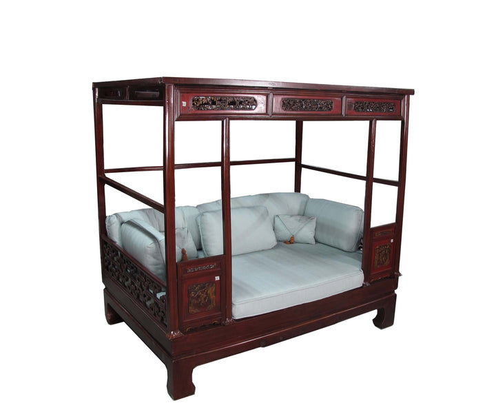 Traditional wooden bed with canopy on a white background