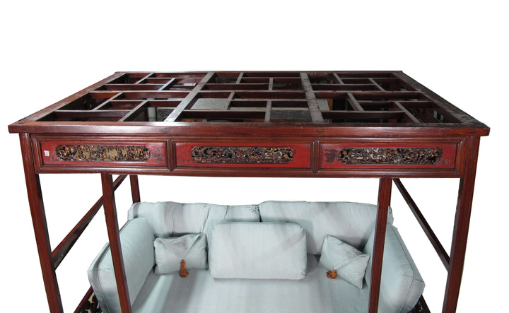 Traditional wooden table with intricate carvings on a white background