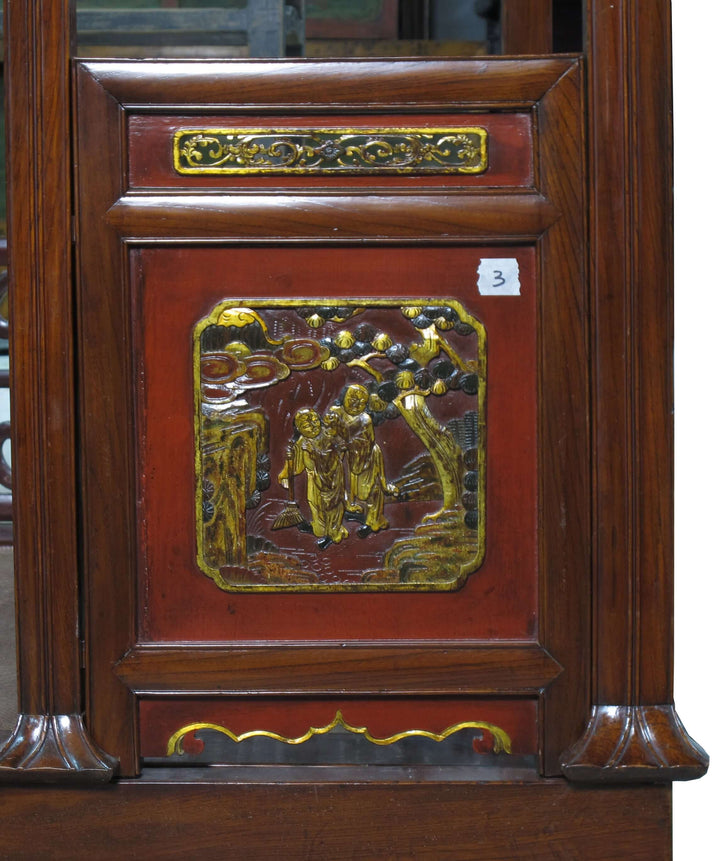 Wooden panel with decorative carvings and gold accents on a wooden structure.