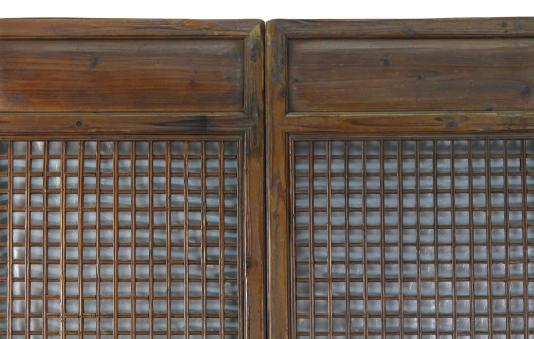 Pair of wooden doors with grid patterns on a white background