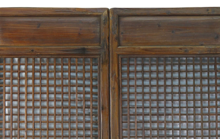Pair of wooden doors with grid patterns on a white background