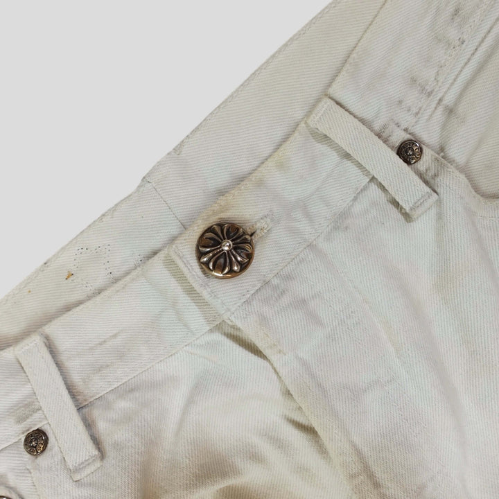 Close-up of the button and waistband design of Chrome Hearts Leopard Cross Patch Jeans in White. Rare luxury jeans.