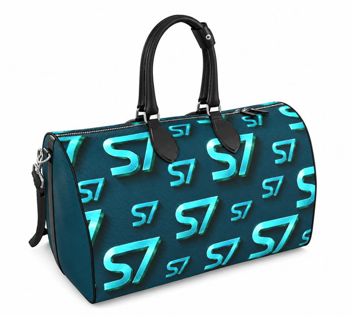 S7 Electric Lagoon bag featuring dimensional turquoise monograms, midnight teal side panels, and nickel-tone hardware.